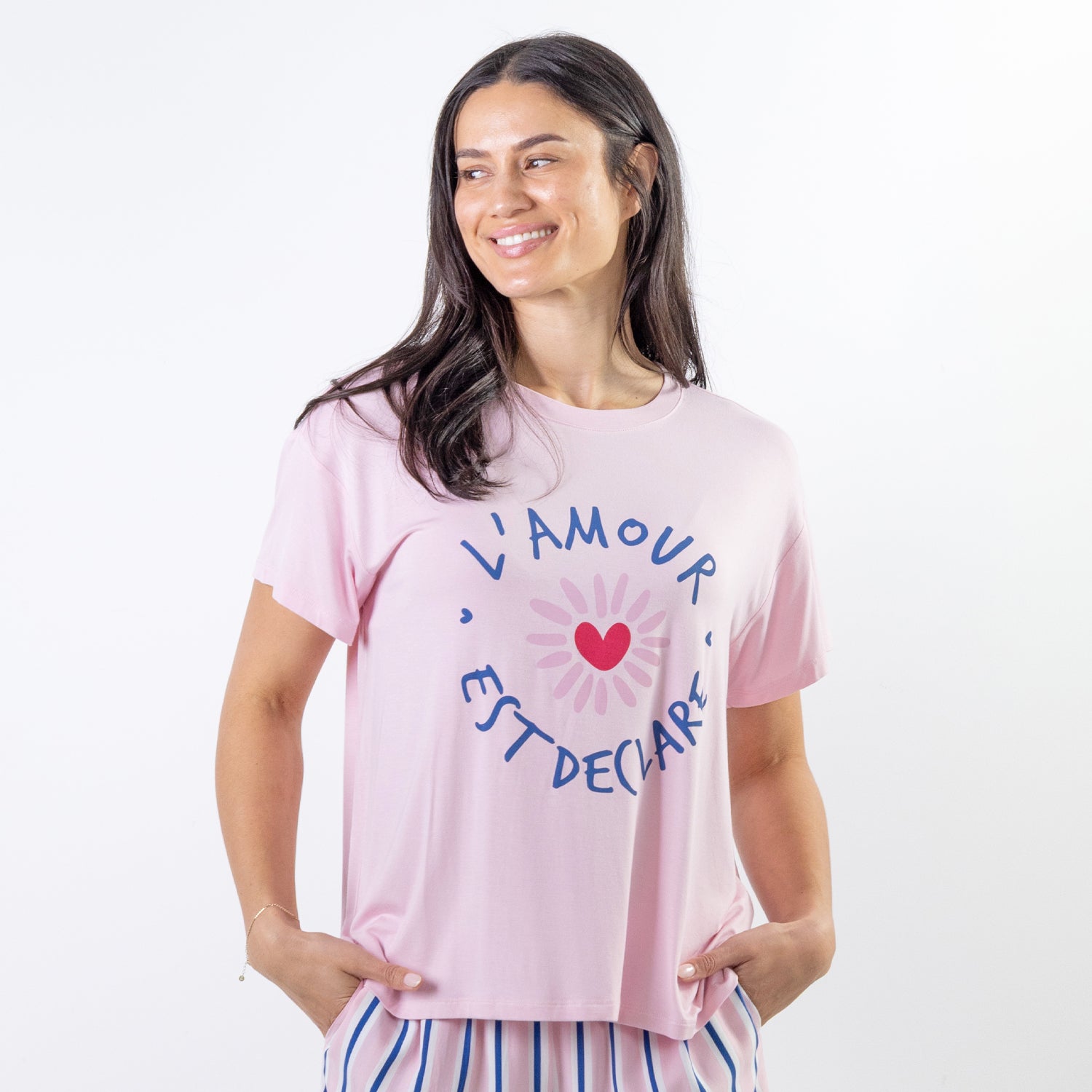 A soft pink sleep tee features a playful heart graphic with the words "L'Amour Est Déclaré," creating a sweet, feminine look that's perfect for cosy nights and relaxed mornings.