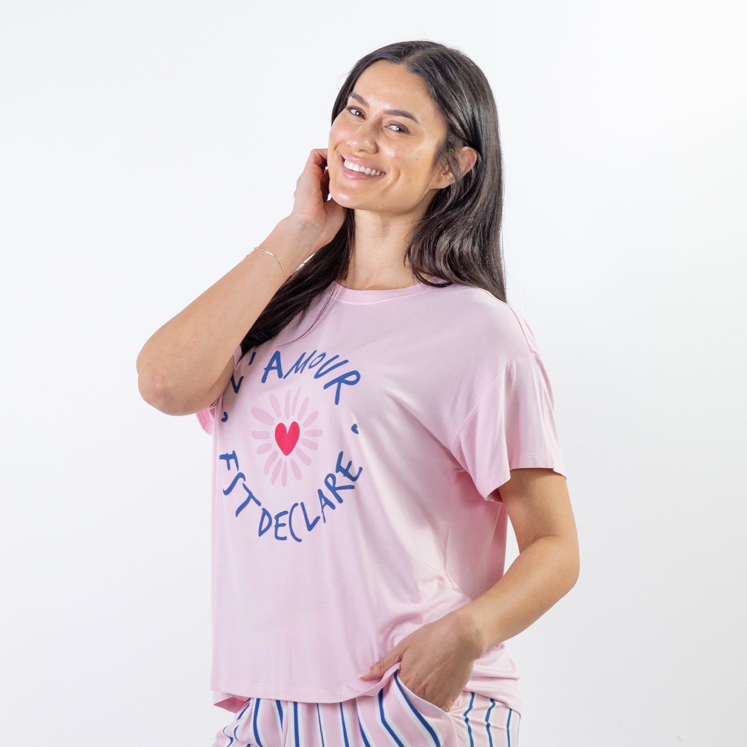 A soft pink sleep tee features a playful heart graphic with the words "L'Amour Est Déclaré," creating a sweet, feminine look that's perfect for cosy nights and relaxed mornings.