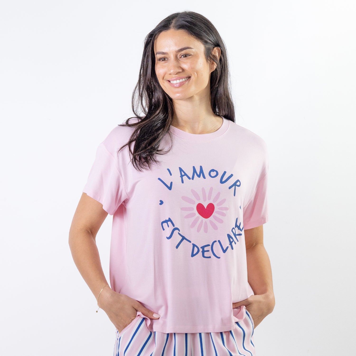 A soft pink sleep tee features a playful heart graphic with the words "L'Amour Est Déclaré," creating a sweet, feminine look that's perfect for cosy nights and relaxed mornings.