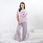 A soft pink sleep tee features a playful heart graphic with the words "L'Amour Est Déclaré," creating a sweet, feminine look that's perfect for cosy nights and relaxed mornings.