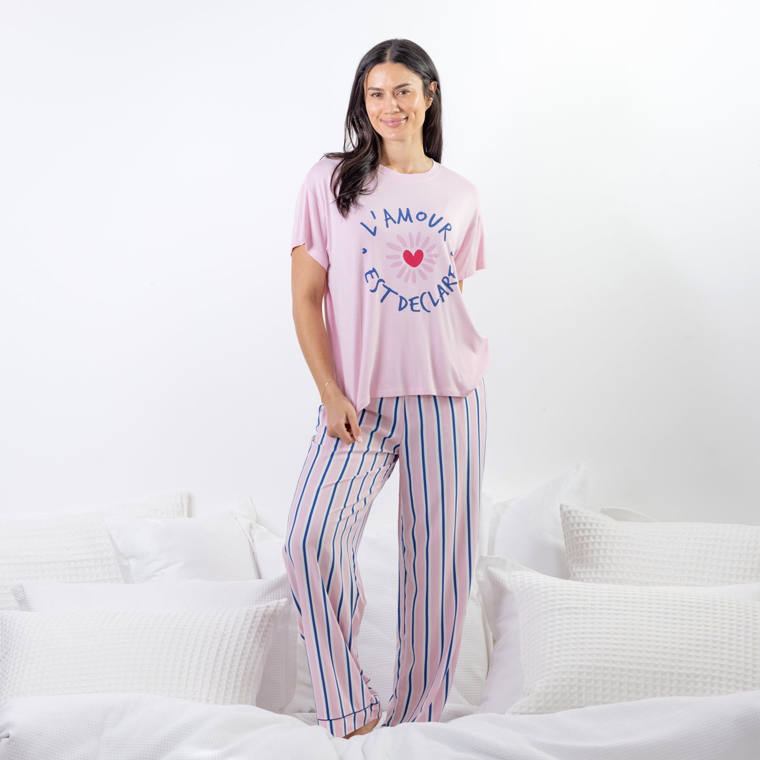 A soft pink sleep tee features a playful heart graphic with the words "L'Amour Est Déclaré," creating a sweet, feminine look that's perfect for cosy nights and relaxed mornings.