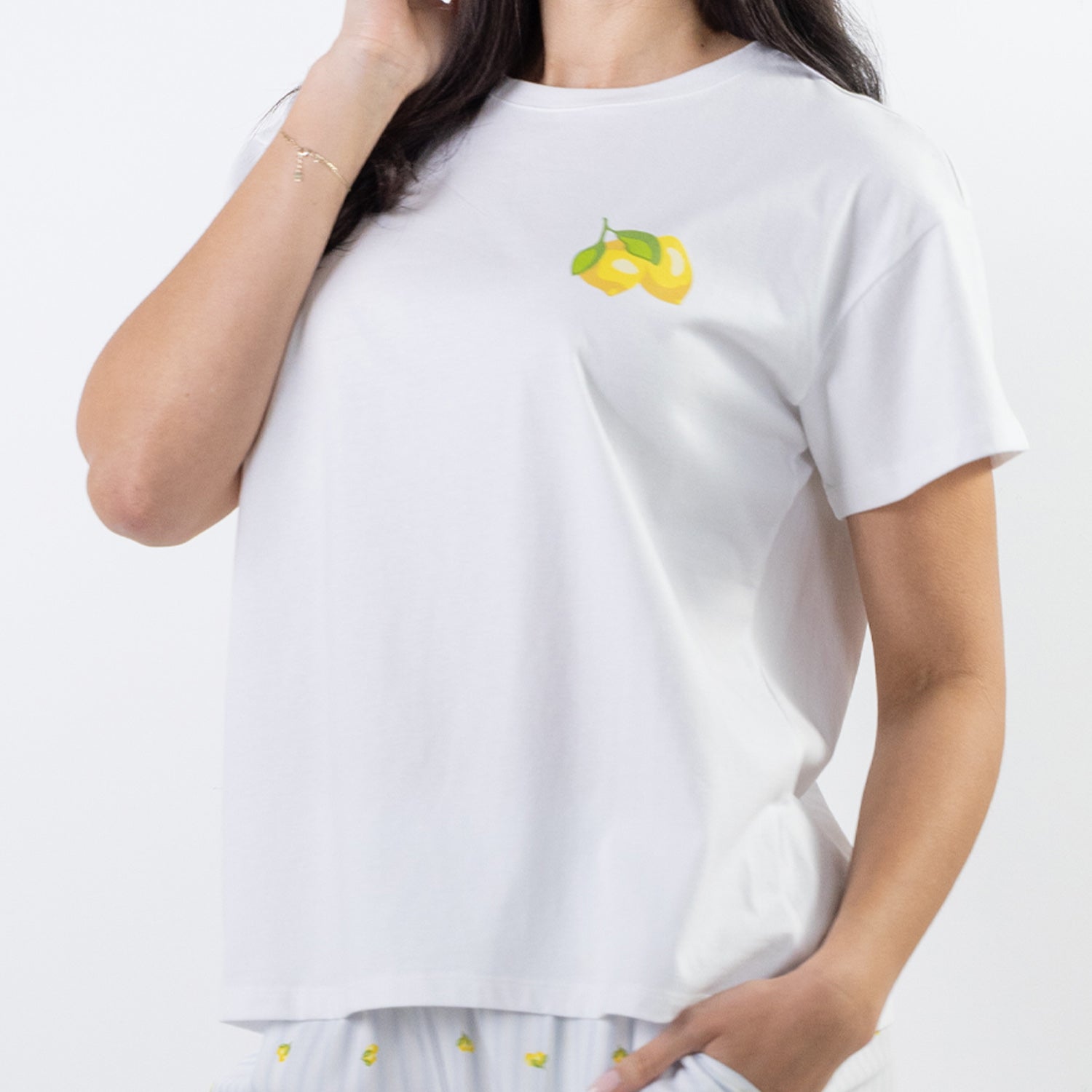 Close-up of the bb&b Sleep Limoncello Print Sleep Tee in White, highlighting the small yellow and green lemon motif on the chest.