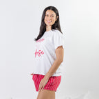 Side view of the bb&b Sleep Strawberry Print Sleep Tee in White, styled with coordinating pink striped sleep shorts.