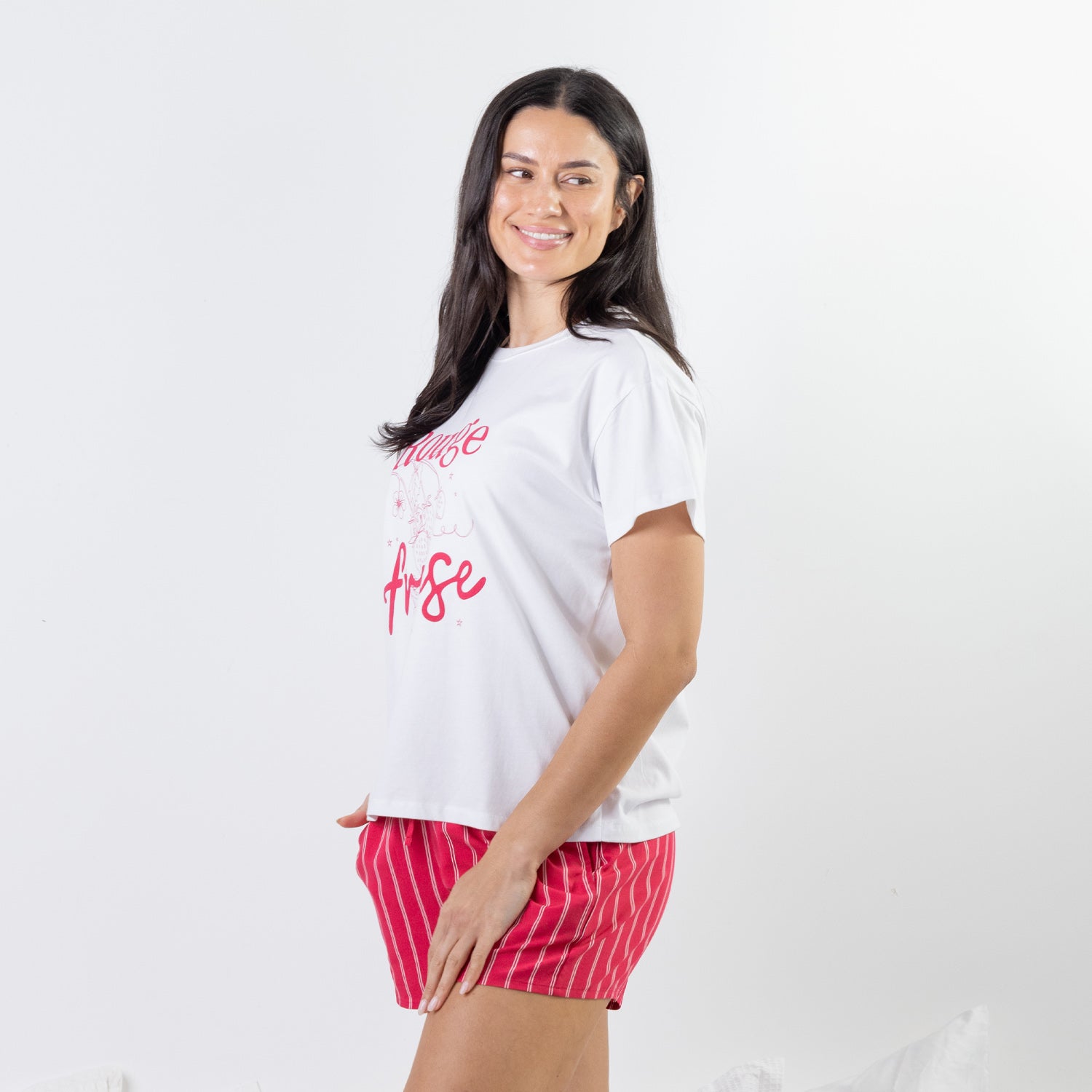 Side view of the bb&b Sleep Strawberry Print Sleep Tee in White, styled with coordinating pink striped sleep shorts.