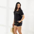 Model wearing the Cove Breeze Stitch Shirt in Black with matching shorts, featuring contrast stitching and a chest pocket.