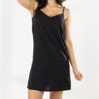 Close-up of the Cove Stitch Slip Dress in Black showing the V-neckline, thin shoulder straps and relaxed fit.