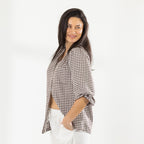 Side view of the model wearing the Cove Breeze Collarless Shirt in Chocolate Check with ivory pants, showing the relaxed fit.