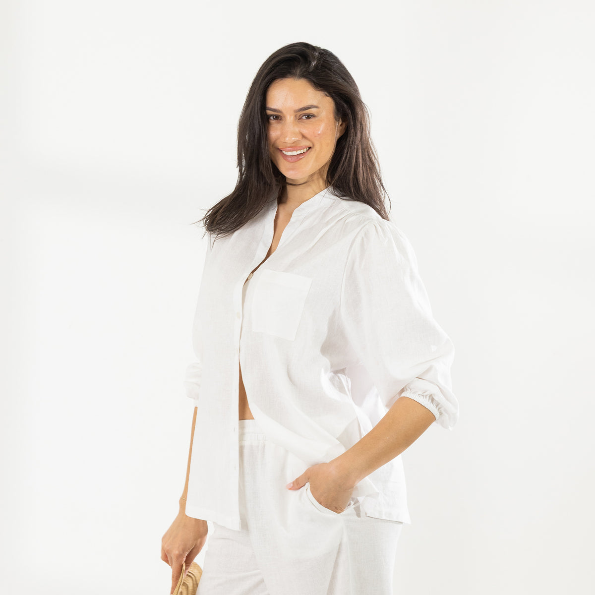 Model wearing the Cove Breeze Collarless Shirt in Ivory with coordinating ivory pants, showing the relaxed fit and collarless neckline.