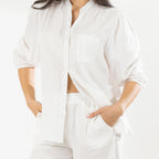 Close-up of the Cove Breeze Collarless Shirt in Ivory, showing the button front, chest pocket and three-quarter sleeves with elasticated cuffs.