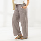 Side view of the Cove Wide Leg Pants in Chocolate, showing the relaxed wide-leg silhouette and side pocket.