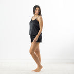 Eden Satin Cami PJ Set in Black shown from the side with a relaxed-fit camisole and matching satin shorts.