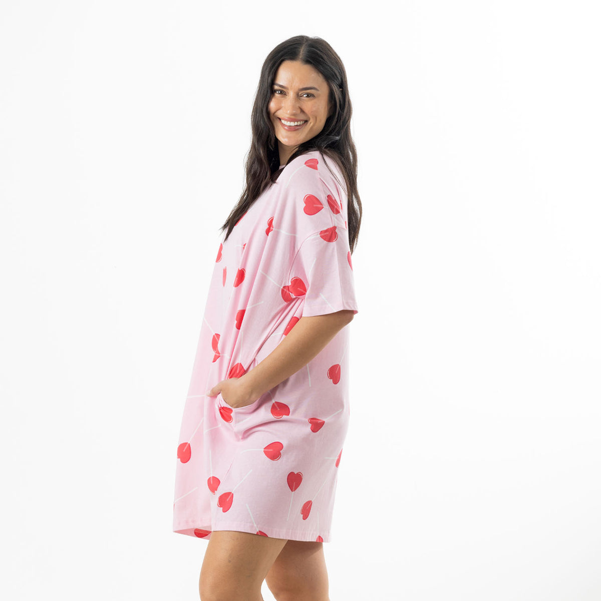 Side view of the soft pink oversized sleep tee showing the relaxed fit, short sleeves and side pocket.