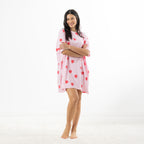 Full-length front view of the soft pink oversized sleep tee with red heart lollipop print, styled against a white studio background.