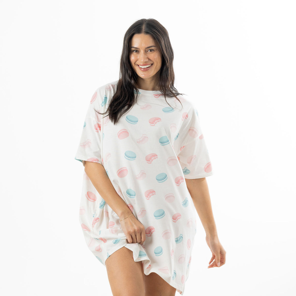 Woman modelling an ivory oversized sleep tee with an all-over pink and blue macaroon print and short sleeves.
