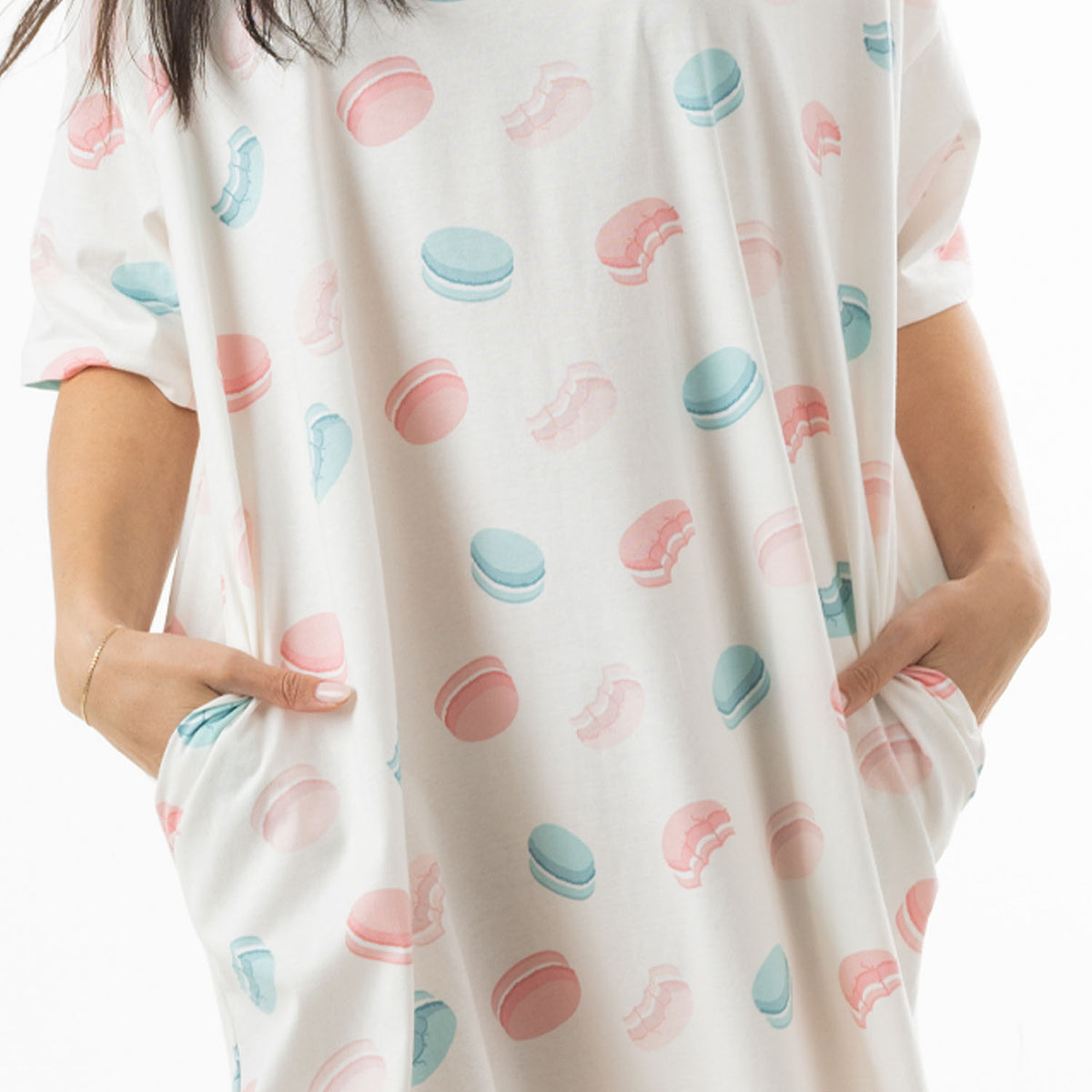 Close-up of the ivory oversized sleep tee showing the pastel pink and blue macaroon print and side pockets.