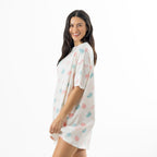 Side view of the ivory oversized sleep tee showing its relaxed silhouette, short sleeves and pastel macaroon pattern.