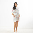 Full-length view of the ivory oversized sleep tee with pink and blue macaroon print and roomy side pockets.