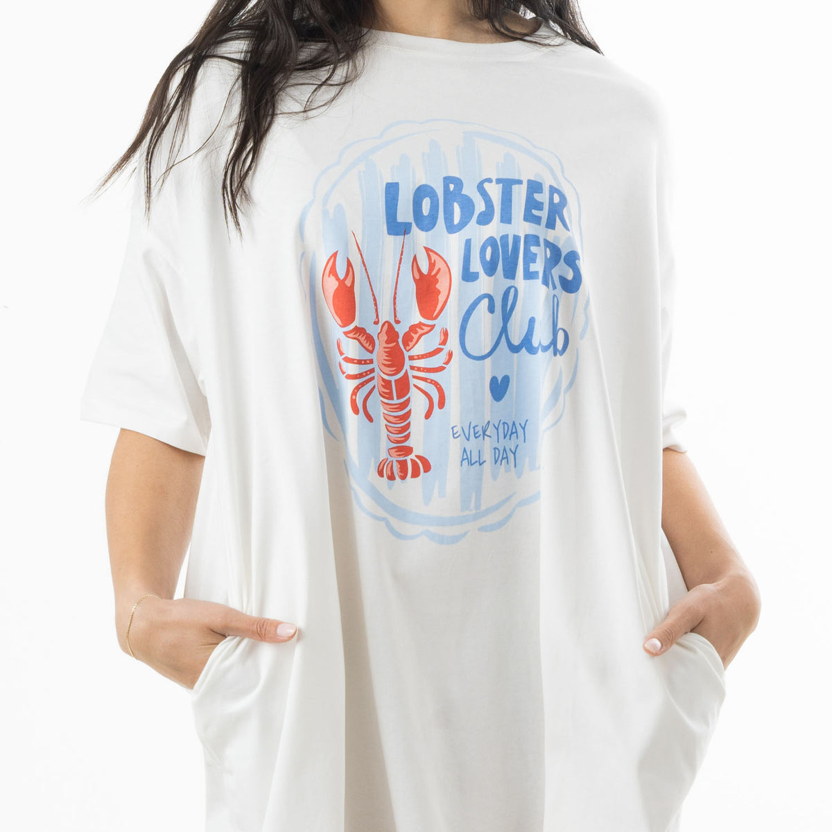 Close-up of the white oversized sleep tee showing the blue Lobster Lovers Club lettering, orange lobster graphic and side pockets.