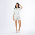 Full-length view of the Amparo Sophie Stripe PJ Set in Blue, featuring a button-up striped top and matching shorts.