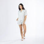 Mid-length view of the Amparo Sophie Stripe PJ Set in Blue, featuring a short-sleeve button-up top and matching striped shorts.