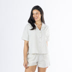 Mid-length view of the Amparo Sophie Stripe PJ Set in Natural, featuring the striped button-up top and matching shorts.