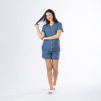 Full-length view of a model wearing the Gracious Living Olivia Embroidered Short PJ Set in navy with scalloped embroidered detailing, paired with white slippers.