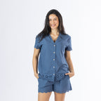 Model wearing the Gracious Living Olivia Embroidered Short PJ Set in navy, featuring a collared button-front top and matching shorts with delicate floral embroidery along the hems.