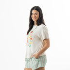 Side view of a model wearing the off-white bb&b Sleep Lobster Print Sleep Tee with short sleeves and mint green striped pyjama shorts.