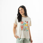 Model wearing an off-white bb&b Sleep Lobster Print Sleep Tee featuring colourful seafood and citrus illustrations, paired with mint green striped pyjama shorts.