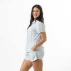 Side view of a model wearing the bb&b Sleep Sea Shells Short Sleeve PJ Set in Denim, showcasing the relaxed fit and matching seashell print.