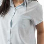 Close-up of the bb&b Sleep Sea Shells Short Sleeve PJ Set, featuring the collared neckline, button-front design, chest pocket and white coastal print.