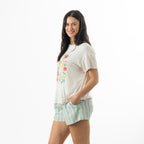 Side view of a model wearing bb&b Sleep Mint Stripe Pyjama Shorts with a cream graphic tee, showcasing the relaxed fit, side pocket and mint striped design.