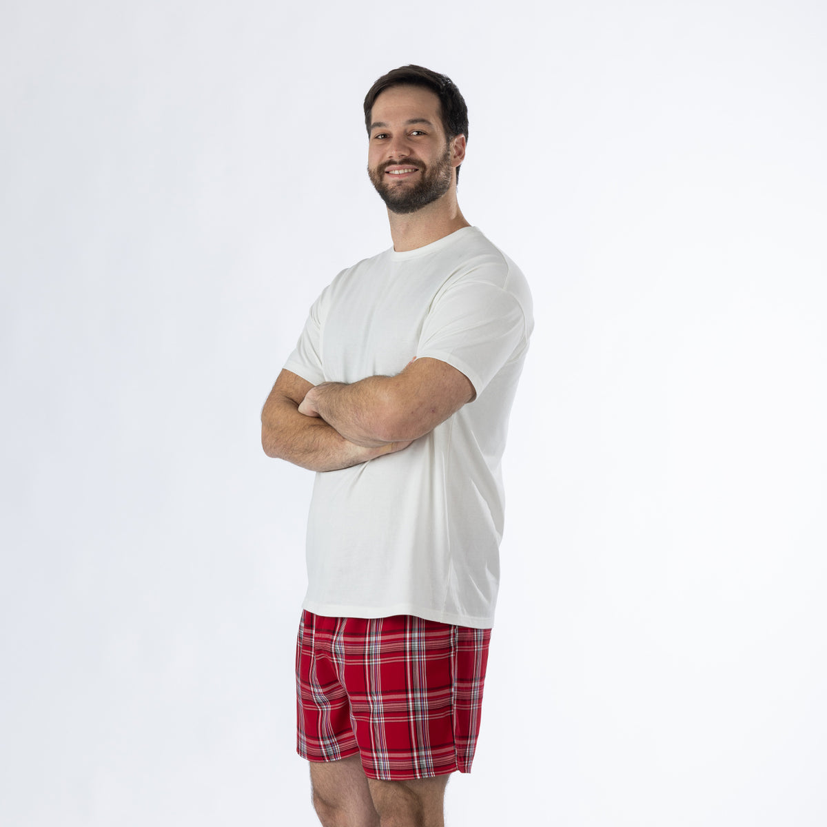 Design Plus Men’s Check PJ Set Red, shown on a model in a relaxed side pose wearing the white T-shirt and red tartan check shorts.
