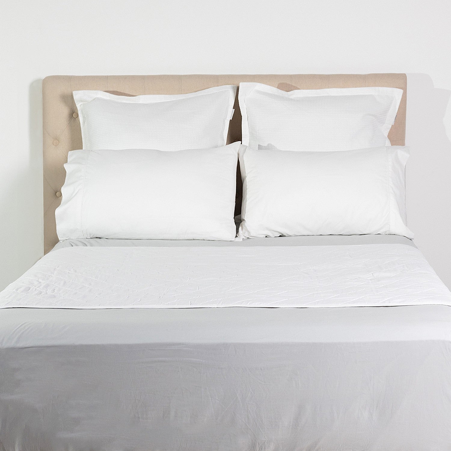 Cloud 9 Mattress or Sheet Waterproof Protector styled on a made bed, designed to protect the mattress while remaining comfortable under bedding.