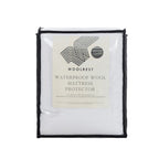 Woolrest Waterproof Wool Mattress Protector packaging showing a wool-filled waterproof mattress protector in a reusable zippered storage bag with product details displayed on the front.
