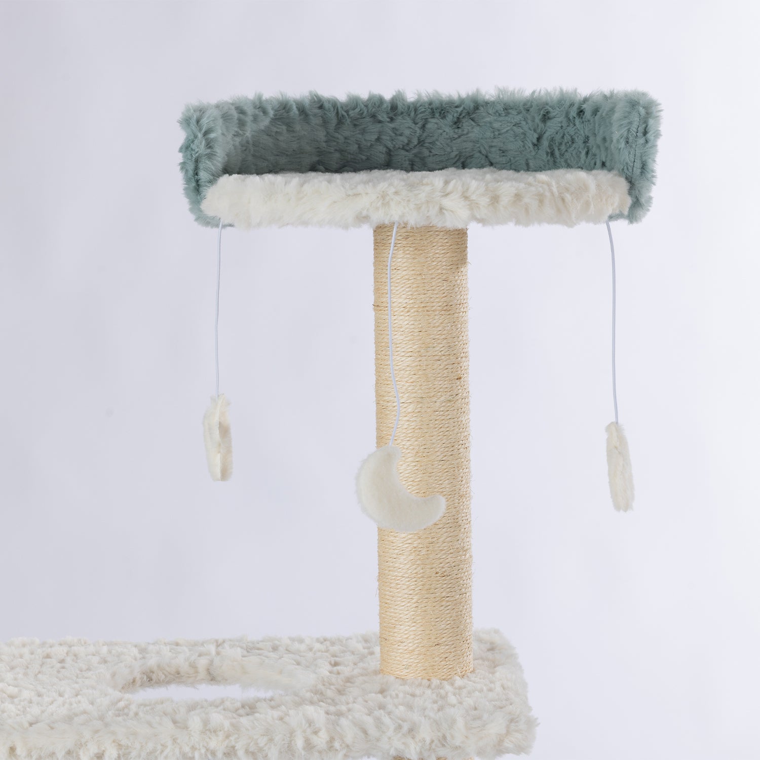 Close-up of the top plush perch with hanging moon and feather toys on the four-tier blue and cream cat tower.