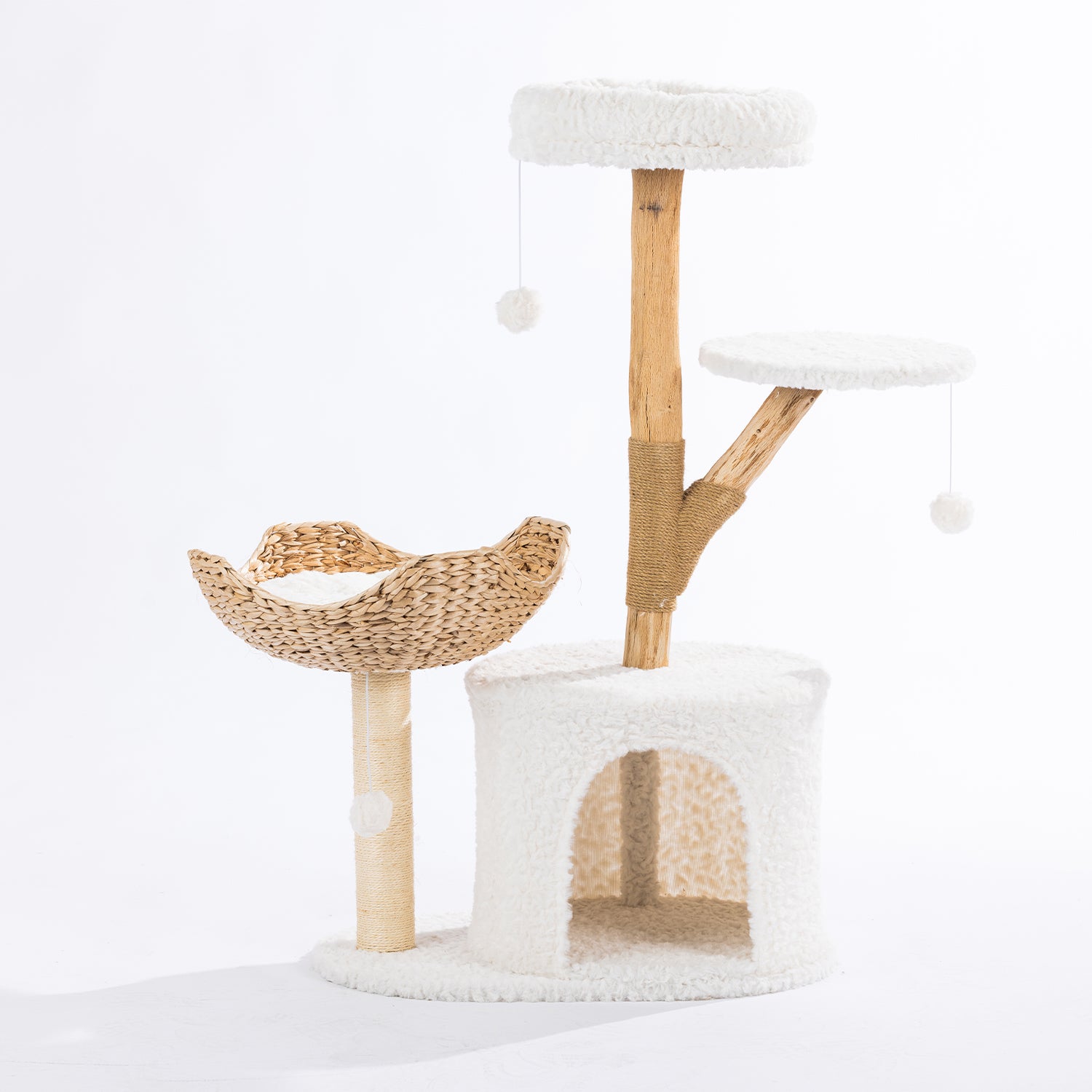 Cream cat tower with a plush hideaway, woven basket bed, elevated perch, natural wood-look scratching post, and dangling pom-pom toys.