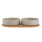 Two mushroom-coloured ceramic pet bowls displayed on a natural bamboo holder.