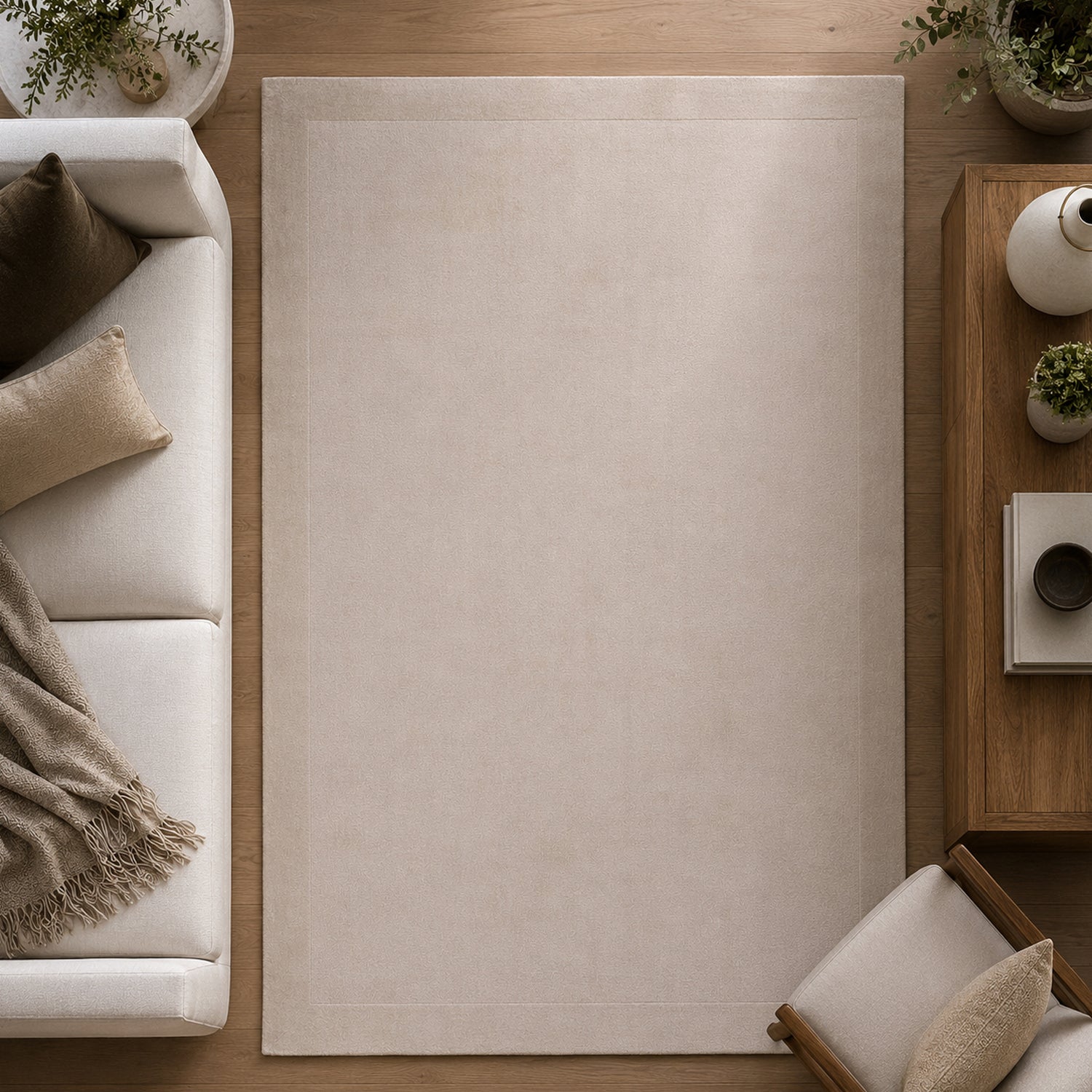 Gracious Living Sabrina Ivory Area Rug with a soft plain design and subtle border detail, styled in a contemporary living room with warm timber flooring, a cream sofa and wooden furniture.