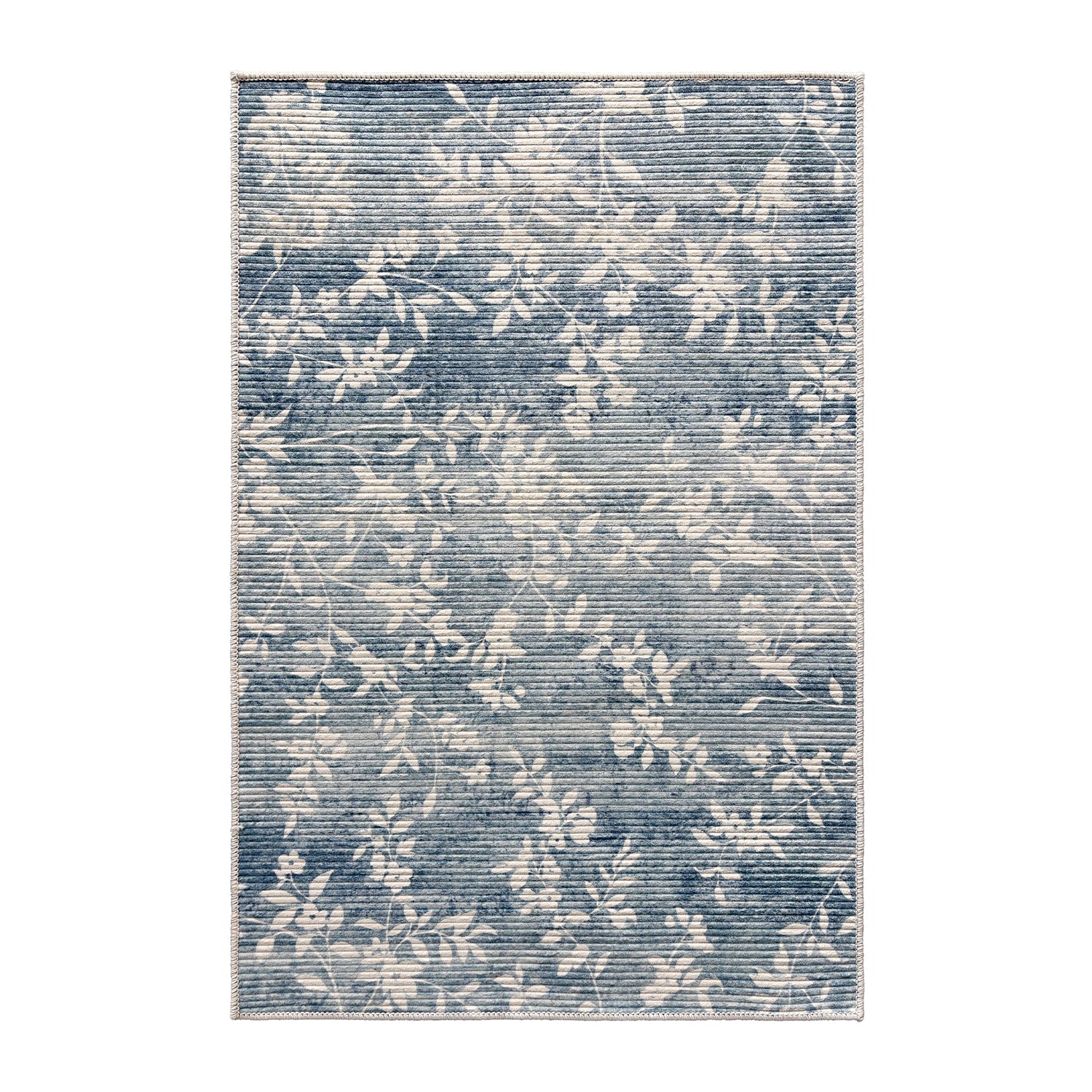 Home Co. Soft Ribbed Everly Rug (160 × 230cm) in Denim, featuring a subtle floral vine pattern in soft denim blue and ivory with a textured ribbed finish.