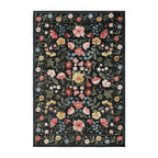 Home Co. Soft Ribbed Everly Rug (160 × 230cm) in Charcoal, featuring a colourful botanical floral pattern with pink, yellow, blue and cream flowers on a charcoal background with a textured ribbed finish.