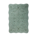 A rectangular area rug with scalloped edges, featuring a muted sage green base with a darker olive green traditional floral medallion pattern, shown against a plain white background.
