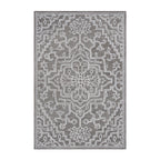 Natural-toned wool rug featuring an intricate ivory medallion pattern with ornate geometric and floral detailing on a soft neutral background.
