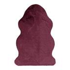 A plush berry novelty rug with a softly contoured silhouette and velvety texture adds a bold, playful accent to any room.