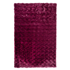 A luxuriously soft faux fur rug with a subtle textured pattern and plush pile brings warmth, comfort, and understated elegance to any living space.