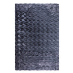 A luxuriously soft faux fur rug with a subtle textured pattern and plush pile brings warmth, comfort, and understated elegance to any living space.