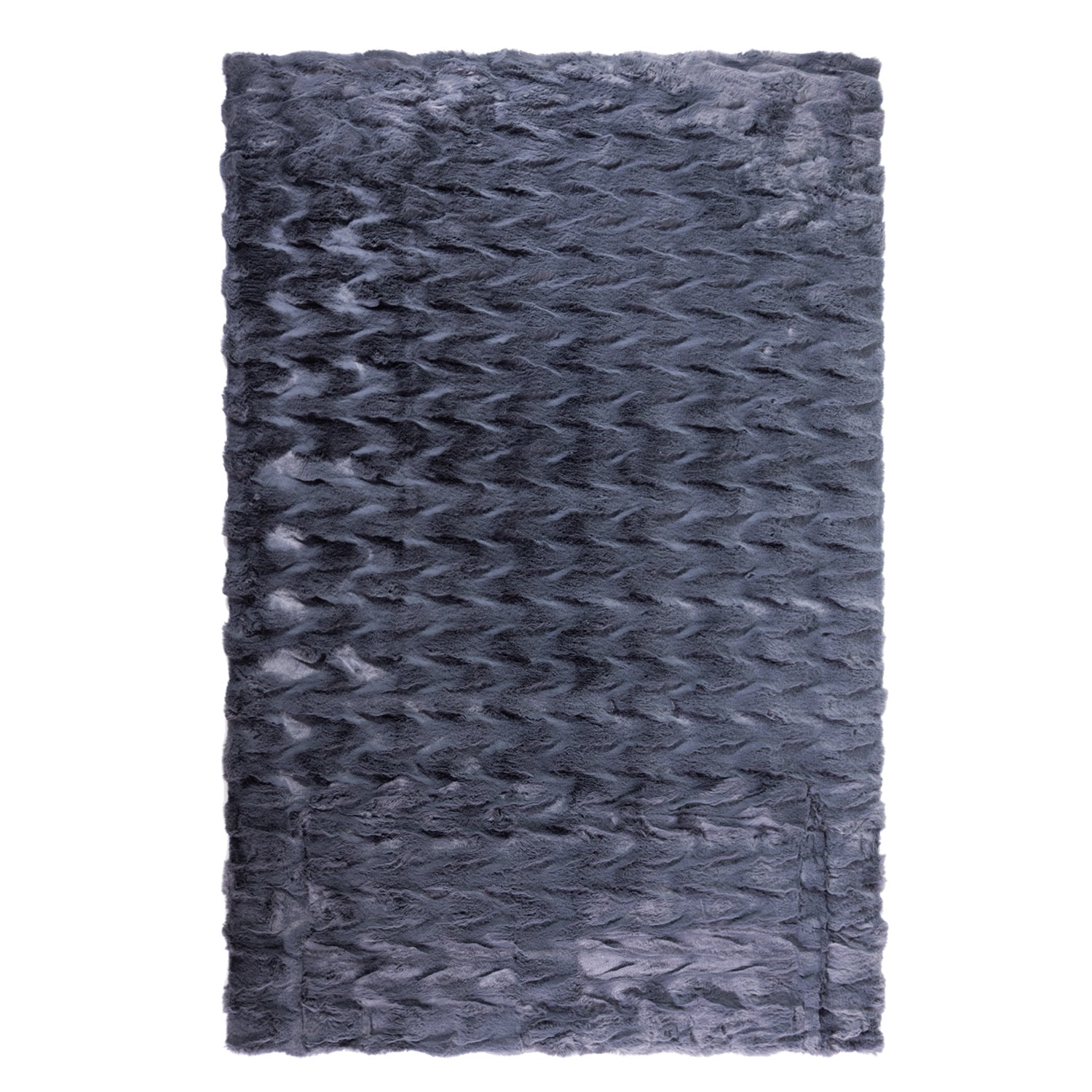 A luxuriously soft faux fur rug with a subtle textured pattern and plush pile brings warmth, comfort, and understated elegance to any living space.