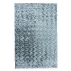 A luxuriously soft faux fur rug with a subtle textured pattern and plush pile brings warmth, comfort, and understated elegance to any living space.