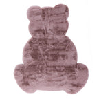 A plush blush pink faux fur rug in the shape of a seated teddy bear, featuring a luxuriously soft texture and a playful silhouette perfect for a nursery or children's bedroom.