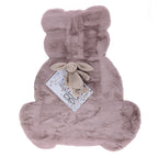 A plush blush pink faux fur rug in the shape of a seated teddy bear, featuring a luxuriously soft texture and a playful silhouette perfect for a nursery or children's bedroom.